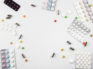 Medical pills on white background. Flat lay frame composition