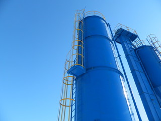  production tanks on a blue sky background