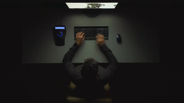 The freelancer works with a 3d modeling in computer. night time. view from above