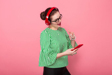 Businesswoman with phone and earphones