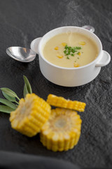 Corn soup in white cup on a table