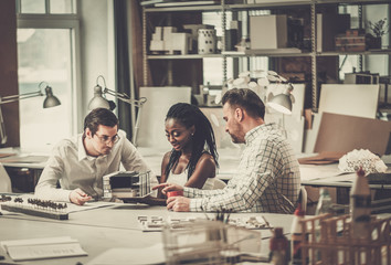 Multiracial team working in design and engineering architecture office.