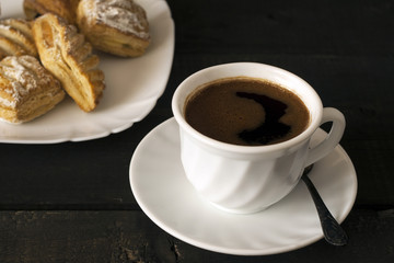 Cup of hot coffee and cookies for breakfast on wooden table