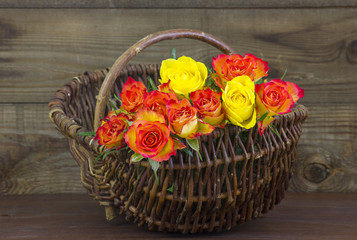 Fototapeta na wymiar orange and yellow roses in a basket
