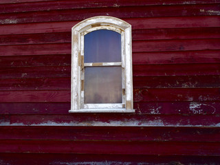 White window on red wood wall