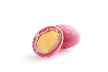 Heap of pink sugared almonds dragees isolated on white background
