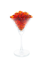 Fish oil soft capsule in cocktail glass with clipping path isolated on white background.