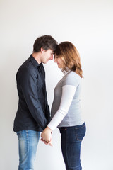 harmony, relationships, valentines day concept. there is a couple of lovers, young man and woman who is waiting a child soon, she is eight months pregnant