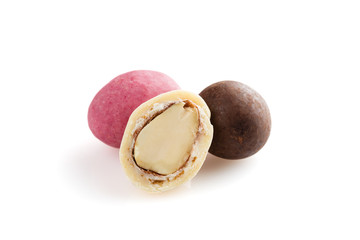 Heap of sugared almonds and hazelnuts dragees in chocolate isolated on white background