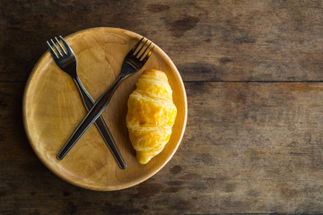 Freshly baked croissants on wooden.