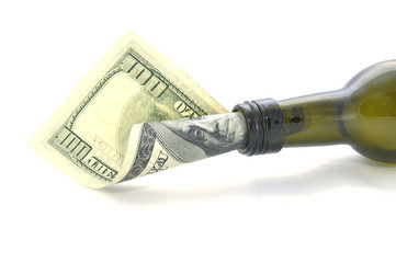Money in bottle on white background close-up 