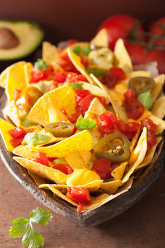 nachos loaded with salsa, cheese and jalapeno