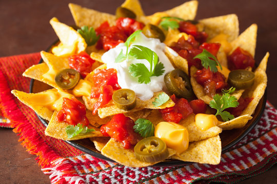 nachos loaded with salsa, cheese and jalapeno