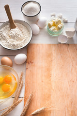 Baking ingredients on rustic wood background