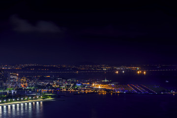 Night view of the top of the Santos Dumont airport at downtown of Rio de Janeiro with lights, buildings and Rio Niteroi bridge at background