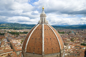 Fototapeta na wymiar Dome of medieval Cathedral of Santa Maria del Fiore close up in the cloudy September afternoon. Florence, Italy