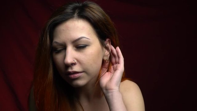 Lovely woman with piercings listens attentively