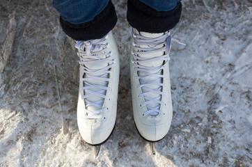 a woman stands in skates in the snow