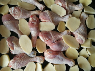 raw chicken legs and potatoes