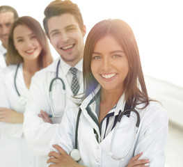 Fototapeta premium female doctor with group of happy successful colleagues
