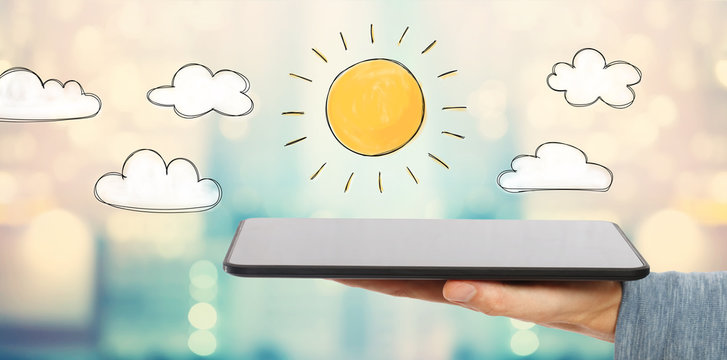 Sunny Day with man holding a tablet computer