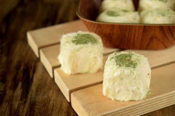 Turkish dessert. Cotton candy with pistachio on wooden boards surrounded by nuts