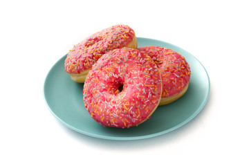 Pink frosted donut with colorful sprinkles. Isolated on white background