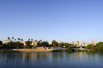 Fototapeta na wymiar Panoramic view of Seville riverbank with La Giralda in the background