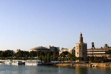 Fototapeta na wymiar Panoramic view of Seville riverbank with the Torre del Oro