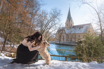 Young woman playing with her dog