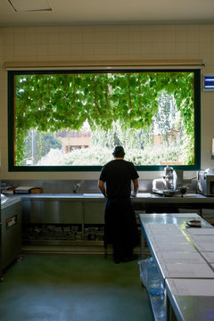 Lonely chef in his big kitchen at the begining of a long workday