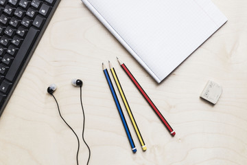 Office table with copybook, computer. View from above
