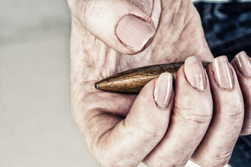 Obraz premium Conceptual photography against the war. A big bullet in the hands of a girl.