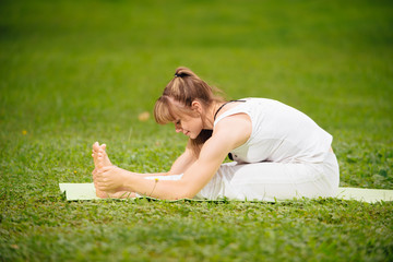 Fototapeta premium woman does Yoga in the park