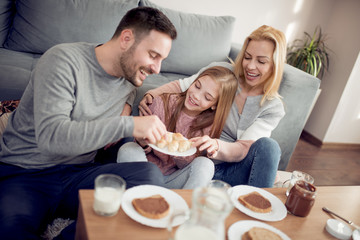 Obraz na płótnie Canvas Happy family having breakfast together at home.