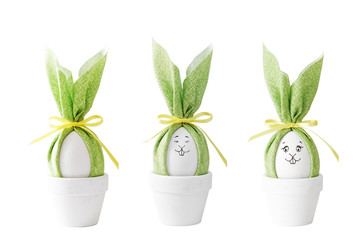 Happy Easter concept. Three Easter bunnies with different faces isolated on white.