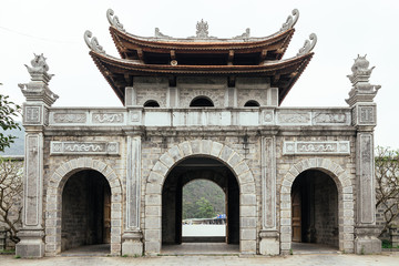 Fototapeta na wymiar Chinese style entrance gate near Trang An Landscape Complex in summer in Ninh Binh, Vietnam.