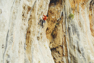 Rock-climbing in Turkey. The guy climbs on the route. Photo from the top.