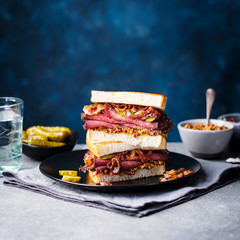 Roast beef sandwich on a plate with pickles. Copy space. © annapustynnikova