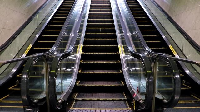 Empty escalator from the metro station. Exit of the subway on the moving stairs.