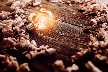 creativity ideas concept with light bulb with wood sawdust on wooden texture table with free copy space for your creativity ideas text
