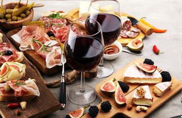 Italian antipasti wine snacks set. Cheese variety, Mediterranean olives, pickles, Prosciutto di Parma and salami
