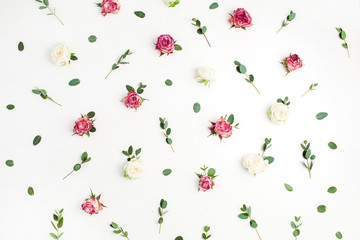 Floral pattern made of red and white rose flower buds and eucalyptus branches on white background....