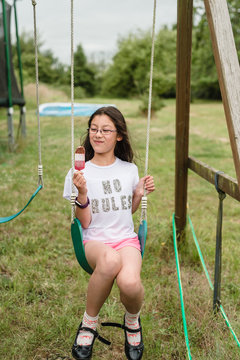 Beautiful mixed race tween girl enjoying an ice lolly