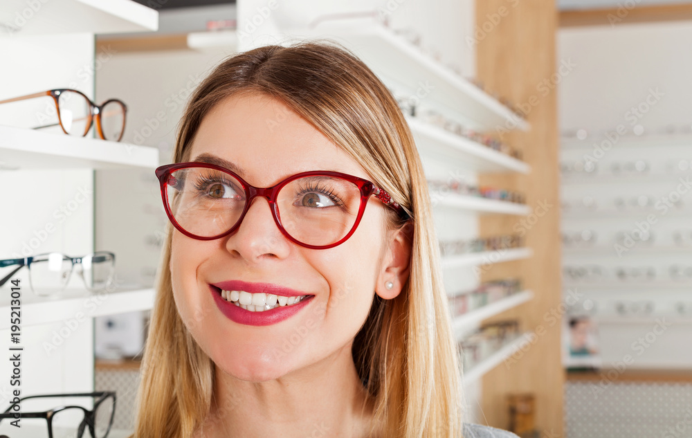 Poster woman choosing eyeglass frame