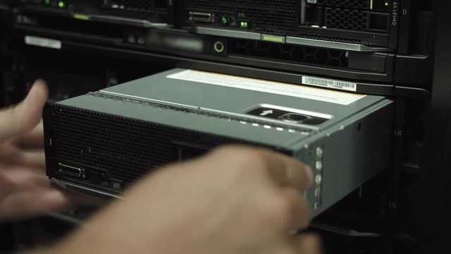 IT engineer replaces hard drive in SAN