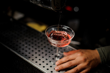 Fresh red cocktail with ice on the bar