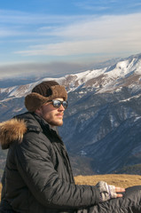 hiker high at the mountains looks at the ultimate aim of his trip.