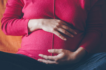 close up of a pregnant woman in natural light