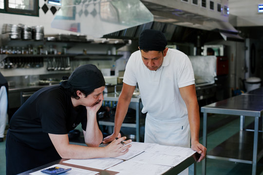 Chef and cook preparing the purchase orders together